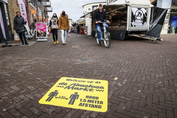 epa08801152 Call to keep a distance due to the corona virus in the center of Almelo, The Netherlands, 05 November 2020. For the region of Twente, just like for Rotterdam-Rijnmond and south-Holland sou ...