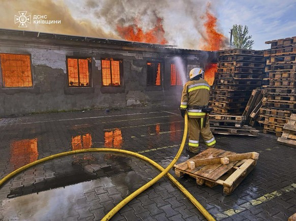 epa12226906 A handout picture made available by the State Emergency Service shows Ukrainian emergency services working at the site of a drone strike in the Kyiv area, Ukraine, 09 July 2025, amid the o ...