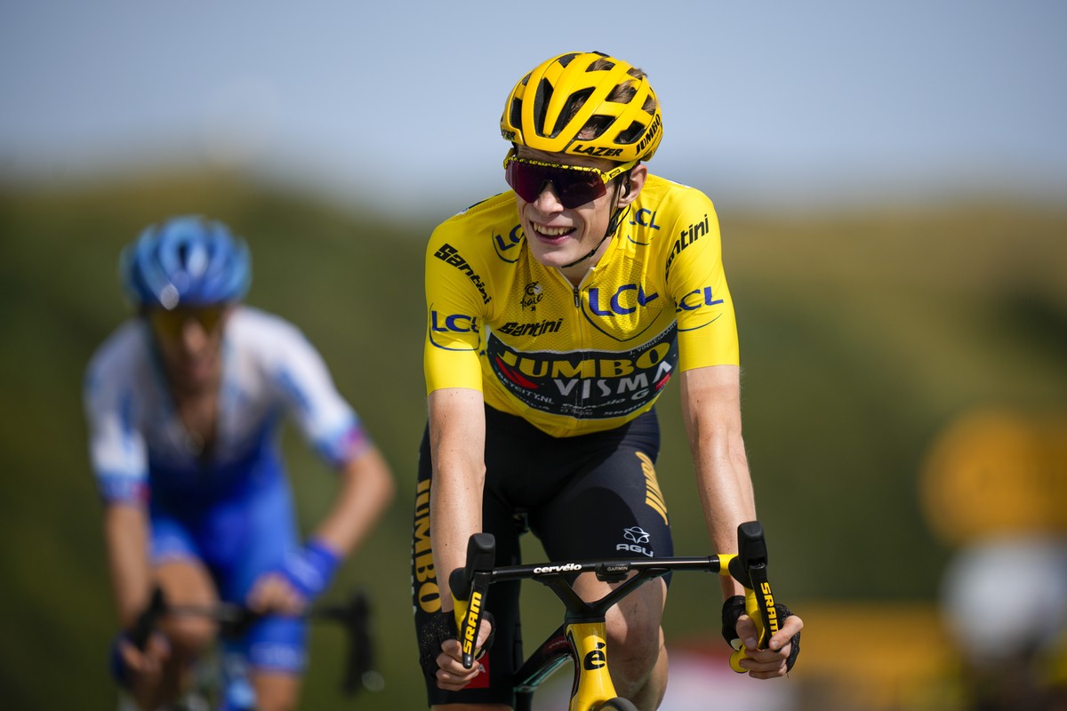 Denmark's Jonas Vingegaard, wearing the overall leader's yellow jersey, celebrates as he crosses the finish line of the twentieth stage of the Tour de France cycling race over 133.5 kilomete ...