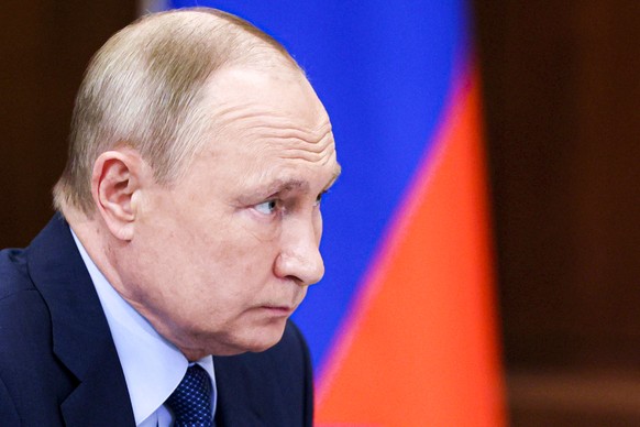 Russian President Vladimir Putin listens during a meeting in the Kremlin in Moscow, Russia, Thursday, Dec. 2, 2021. (Mikhail Metzel, Sputnik, Kremlin Pool Photo via AP)