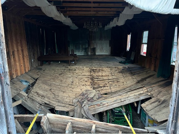 A photo provided by the New Hampshire State Fire Marshal's Office shows the buckled floor that collapsed Saturday, sending nearly 70 wedding guests into the basement of a building in Tamworth, N. ...