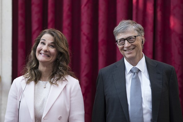 FILE - In this April 21, 2017, file photo, Philanthropist and co-founder of Microsoft, Bill Gates, right, and his wife Melinda react, prior to being awarded the Legion of Honour at the Elysee Palace i ...