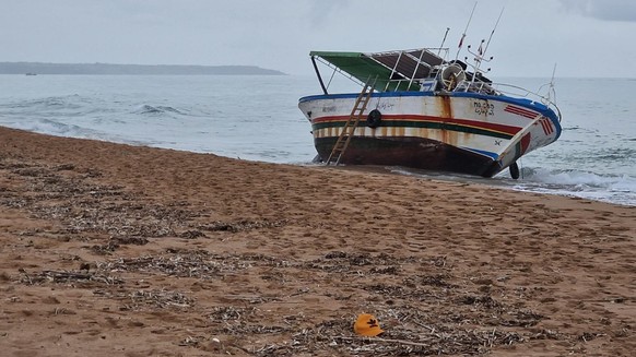 epa10944700 A view of the boat used for the crossing of the Mediterranean Sea by dozens of migrants on the beach of Marinella di Selinunte, Sicily, Italy 28 October 2023. Five bodies were recovered on ...