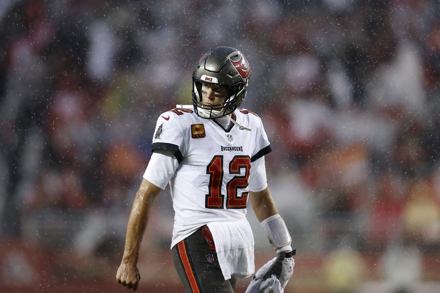 Rain falls as Tampa Bay Buccaneers quarterback Tom Brady walks on the field during the second half of an NFL football game against the San Francisco 49ers in Santa Clara, Calif., Sunday, Dec. 11, 2022 ...