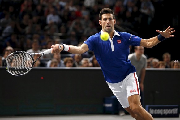 Novak Djokovic of Serbia returns the ball to Tomas Berdych of the Czech Republic in their men&#039;s singles quarter-final tennis match at the Paris Masters tennis tournament at the Bercy sports hall  ...