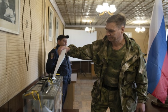 FILE A Luhansk People's Republic serviceman votes in a polling station in Luhansk, Luhansk People's Republic, controlled by Russia-backed separatists, eastern Ukraine, Friday, Sept. 23, 2022. Voting b ...