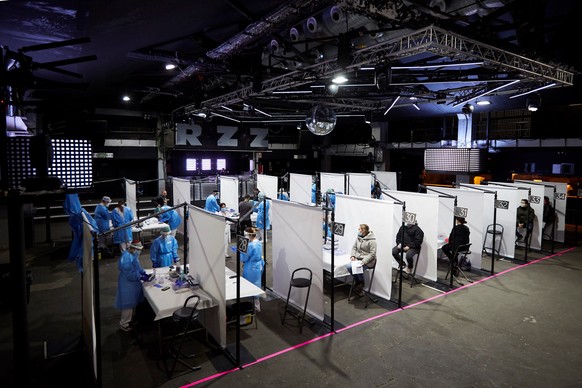 epa09100688 Health workers make coronavirus tests to the 5,000 people who will attend a Love of Lesbian concert at Palau Sant Jordi in Barcelona, Spain, 27 March 2021. People will attend this test con ...