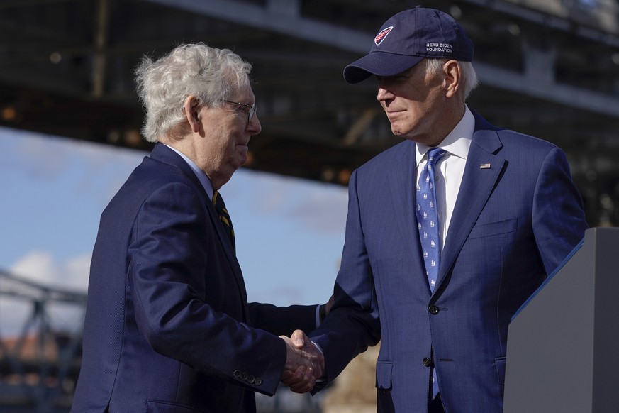 President Joe Biden shakes hands with Senate Minority Leader Mitch McConnell of Ky., after speaking about his infrastructure agenda under the Clay Wade Bailey Bridge, Wednesday, Jan. 4, 2023, in Covin ...