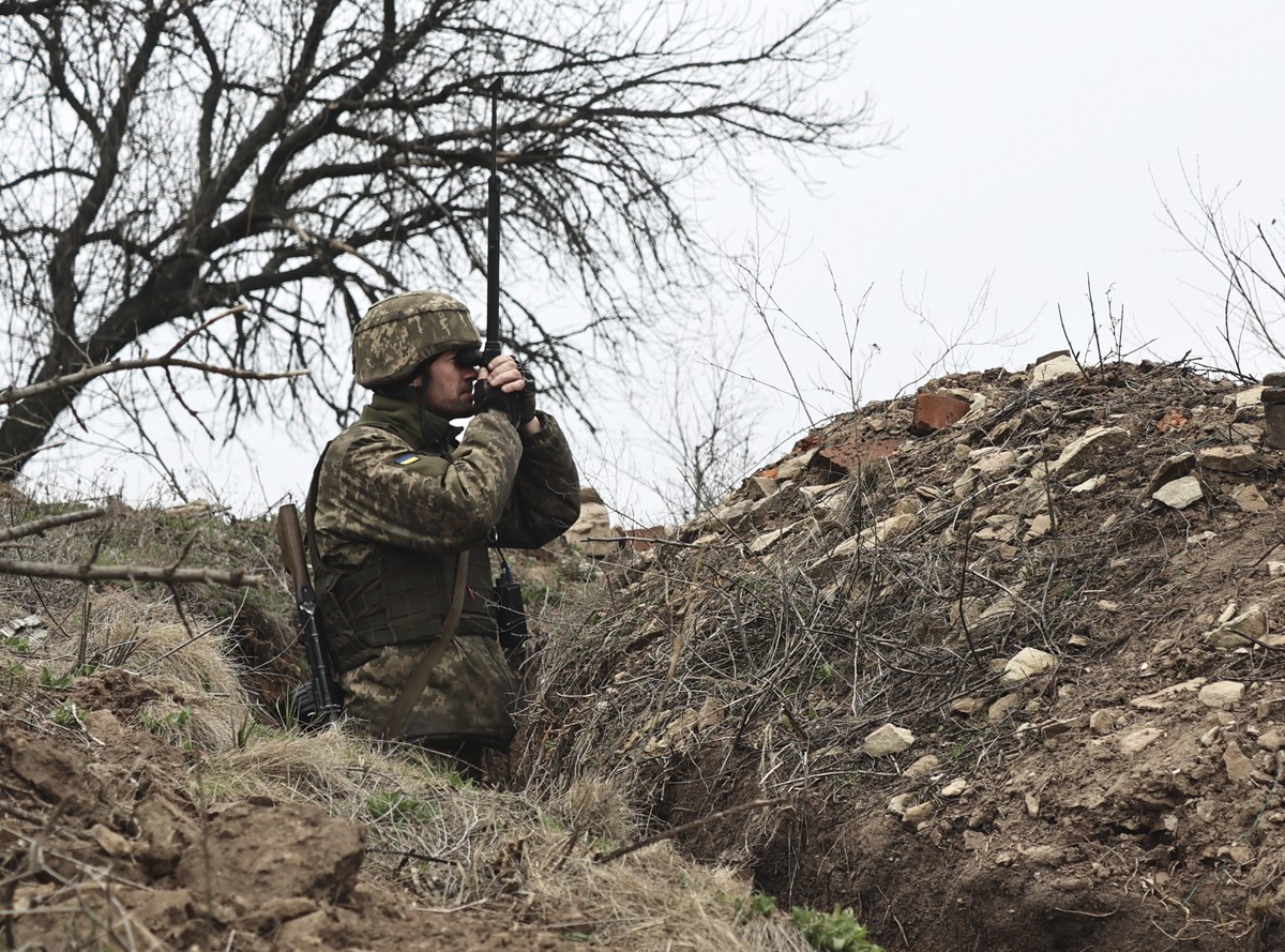 A Ukrainian soldier is seen at fighting positions on the line of separation from pro-Russian rebels near Donetsk, Ukraine, Monday, April 12, 2021. Ukraine's President Volodymyr Zelenskyy has requ ...