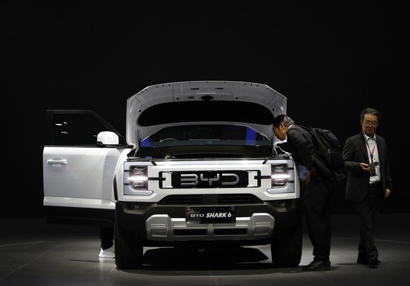 epa11985067 Visitors inspect a Chinese EV, the BYD Shark 6, displayed at the 46th Bangkok International Motor Show 2025 automobile showcase in Nonthaburi, on the outskirts of Bangkok, Thailand, 24 Mar ...