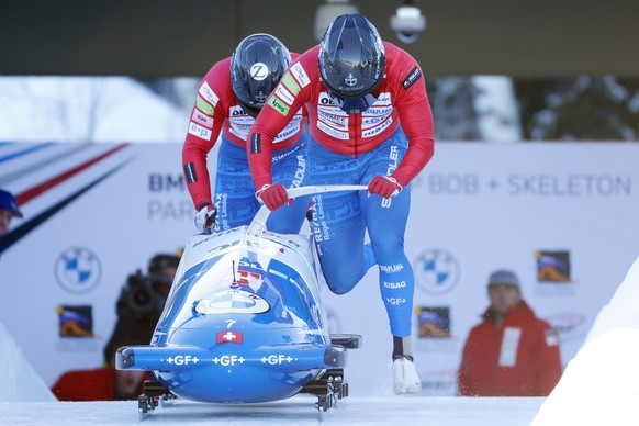 Driver Michael Vogt, front, and Sandro Michel, of Switzerland, compete in the men's two-man bobsled World Cup race Friday, Dec. 2, 2022, in Park City, Utah. (AP Photo/Jeff Swinger)
Michael Vogt,Sandro ...