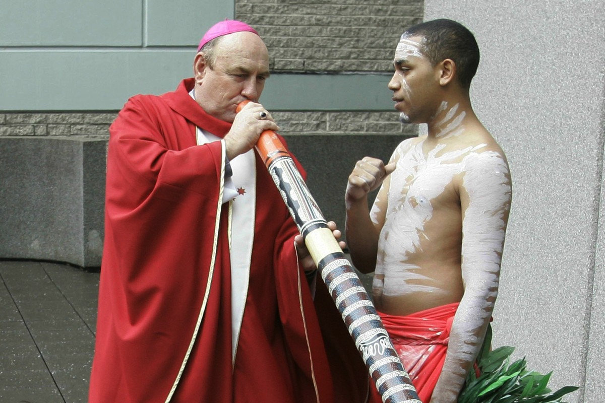 FILE - Bishop Christopher Saunders of Broome tries to play a digeridoo during a World Youth Day 2008 media event in Sydney, Australia, on April 17, 2008. Saunders, a retired Catholic bishop, has been  ...