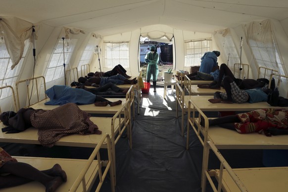 A health worker prepares to clean the floors in a ward with people diagnosed with cholera at a treatment centre in Beira, Mozambique, Saturday, March 30, 2019. Cholera cases among cyclone survivors in ...