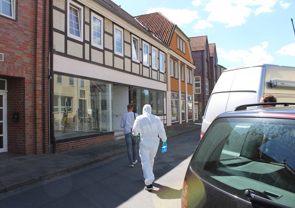 epa07567325 Police agents walk towards a building in Wittingen, northern Germany, 13 May 2019. Two female dead bodies have been found in a flat in the house, killed by a crossbow according to locla me ...