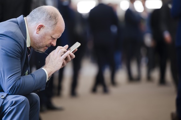 A man uses a mobile phone during the 51st annual meeting of the World Economic Forum, WEF, in Davos, Switzerland, on Tuesday, May 24, 2022. The forum has been postponed due to the Covid-19 outbreak an ...