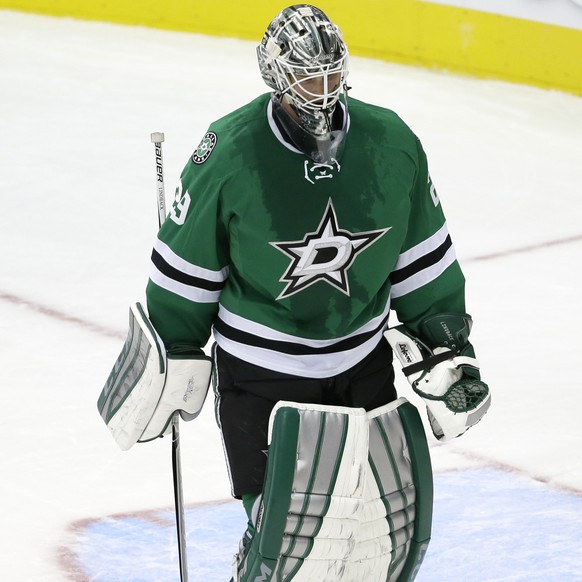 Dallas Stars goalie Anders Lindback, of Sweden, skates by a puck after the net was knocked off its pins on a Carolina Hurricanes score in the third period of an NHL hockey game, Tuesday, Nov. 18, 2014 ...