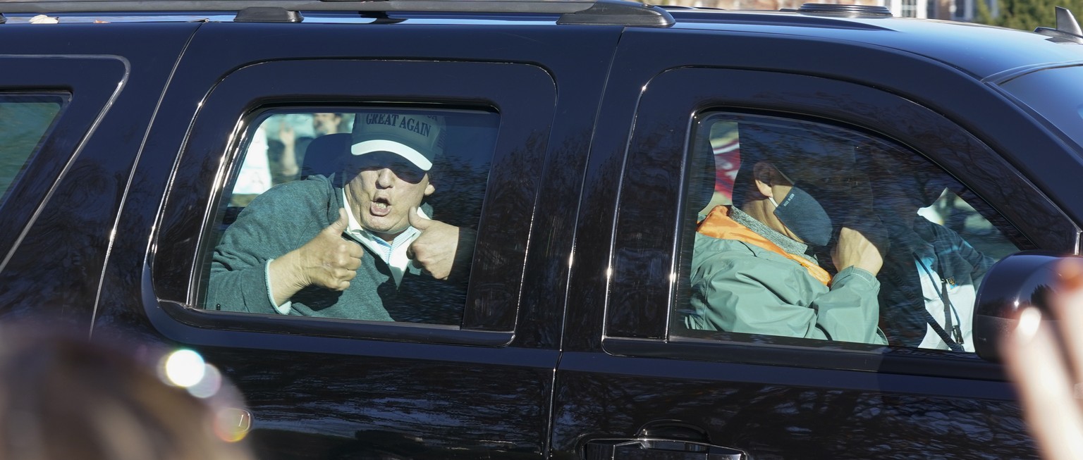 President Donald Trump gives two thumbs up to supporters as he departs after playing golf at the Trump National Golf Club in Sterling Va., Sunday Nov. 8, 2020. (AP Photo/Steve Helber)
Donald Trump