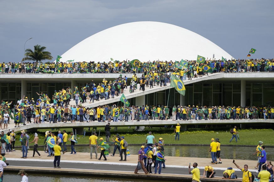 Protesters, supporters of Brazil's former president Jair Bolsonaro, storm the National Congress building in Brasilia, Brazil, Sunday, Jan. 8, 2023. (AP Photo/Eraldo Peres)