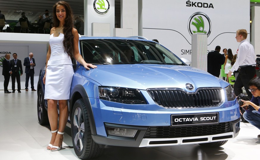 A model poses with Skoda Octavia Scout car during the media day ahead of the 84th Geneva Motor Show at the Palexpo Arena in Geneva March 4, 2014. The Geneva Motor Show will run from March 6 to 16. REU ...