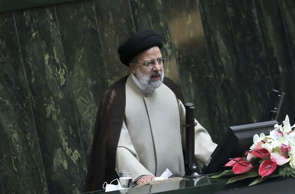 Iranian President Ebrahim Raisi addresses during a joint session of lawmakers and cabinet members at the parliament, in Tehran, Iran, Wednesday, Dec. 1, 2021. They met Wednesday to discuss the budget  ...