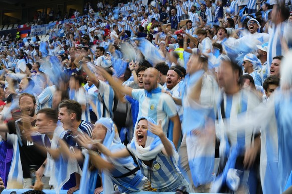 Argentinian fans cheer before the the World Cup final soccer match between Argentina and France at the Lusail Stadium in Lusail, Qatar, Sunday, Dec. 18, 2022. (AP Photo/Petr David Josek)