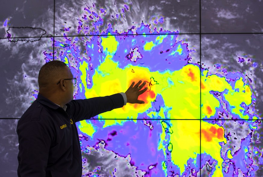 epa07798385 An official from the Emergency Operations Center (COE) describes storm patterns as part of a hurricane alert in the east of the country due to tropical storm Dorian; which has entered the  ...