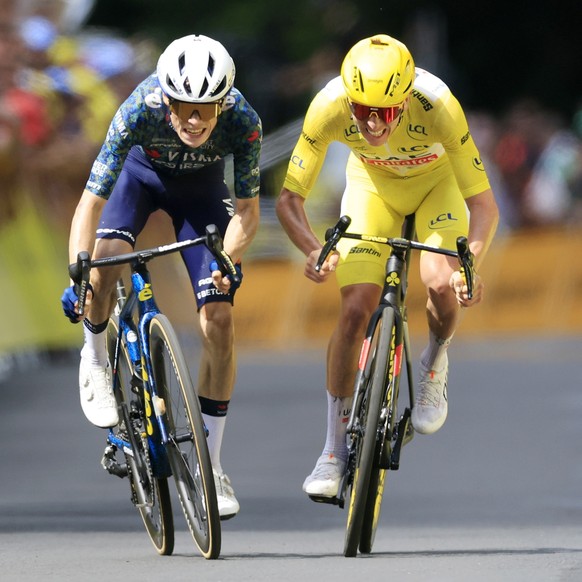 epa11470342 epa11470341 Danish rider Jonas Vingegaard (L) of Team Visma Lease a Bike fights to cross the finish line ahead of yellow jersey Slovenian rider Tadej Pogacar of UAE Team Emirates to win th ...