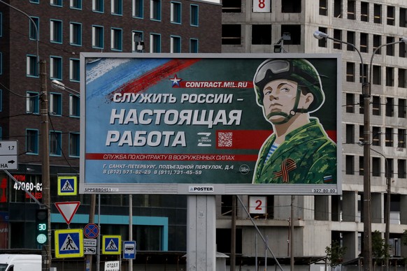 epa10195298 A billboard depicting a soldier with the slogan 'Serving Russia is a real job' stands in St. Petersburg, Russia, 20 September 2022. On 24 February 2022 Russian troops entered the Ukrainian ...