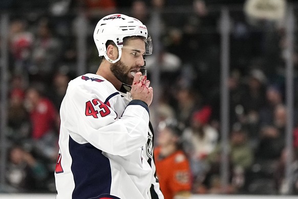 Washington Capitals right winger Tom Wilson skates down the ice after getting into a fight with Anaheim Ducks defenseman Nathan Beaulieu during the third period of an NHL hockey game Wednesday, March 1, 2023, in Anna...