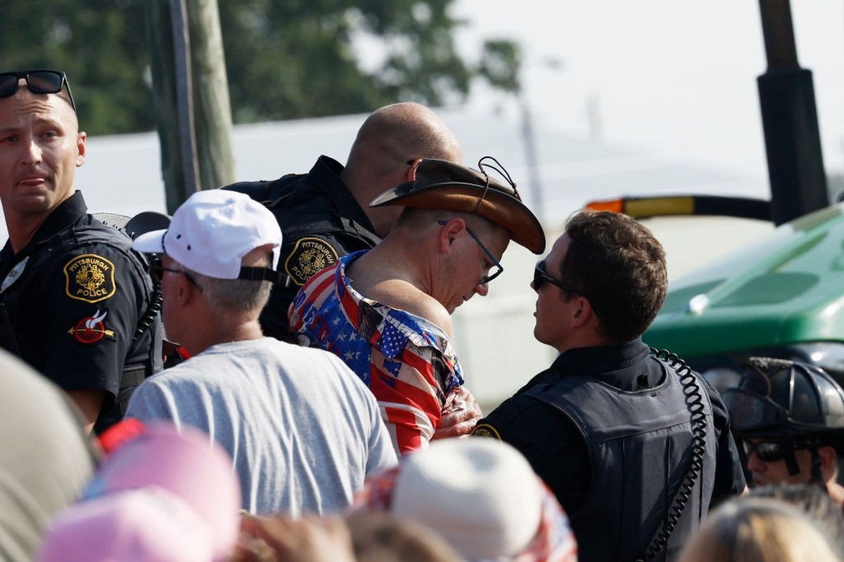 BUTLER, PENNSYLVANIA - JULY 13: Law enforcement officers tend to a man at republican presidential candidate former President Donald Trump's rally on July 13, 2024 in Butler, Pennsylvania. Butler  ...