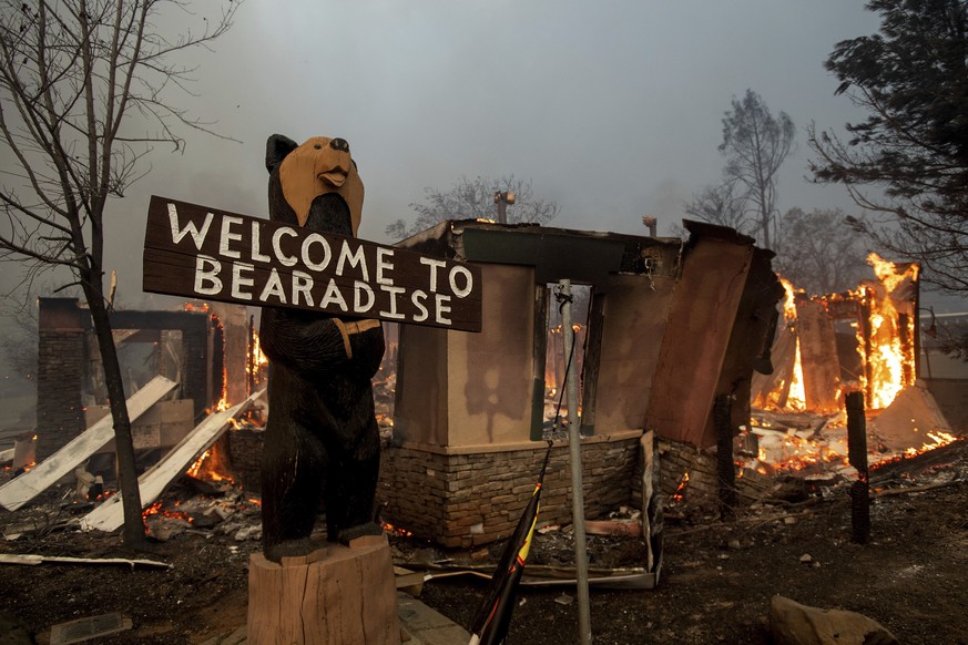 Flames consume a building as the Camp Fire tears through Paradise, Calif., on Thursday, Nov. 8, 2018. A California fire official says a fast-moving wildfire in Northern California has destroyed struct ...