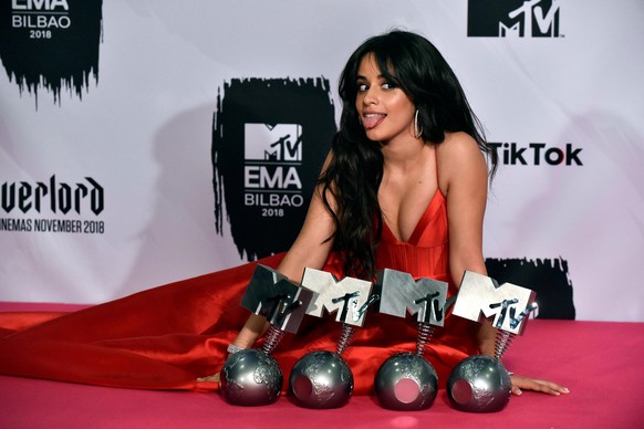 epa07142007 Cuban singer Camila Cabello poses for the photographers after receiving several awards during the 2018 MTV Europe Music Awards at Bilbao Exhibition Centre, in Bilbao, Basque Country, Spain ...