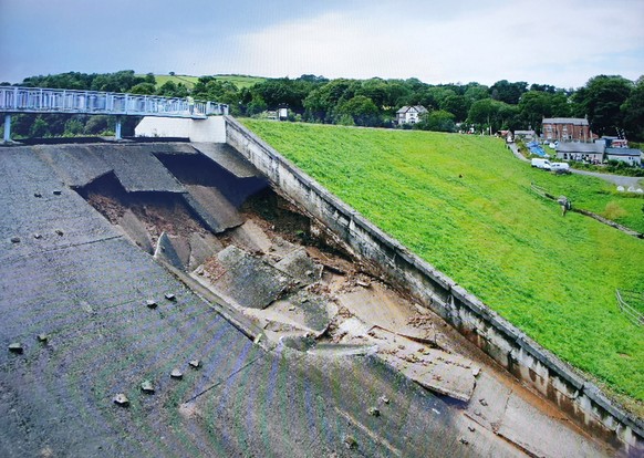 epa07753245 A handout photo made available by the Derbyshire Constabulary police force shows damage to the Toddbrook Reservoir dam above the town of Whaley Bridge, in northern England, Britain, 01 Aug ...