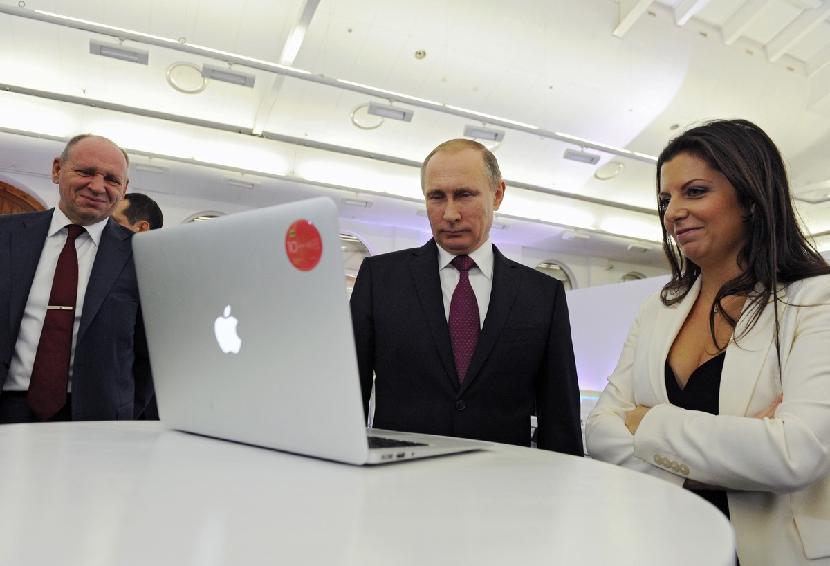 Russian President Vladimir Putin and Editor-in-chief of RT (Russia Today) 24-hour English-language TV news channel, Margarita Simonyan, attend an exhibition marking RT's 10th anniversary in Mosco ...