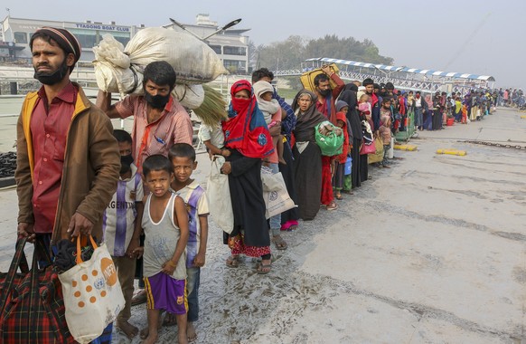 FILE - In this Feb. 15, 2021, file photo, Rohingya refugees headed to the Bhasan Char island prepare to board navy vessels from the south eastern port city of Chattogram, Bangladesh. Authorities in Ba ...