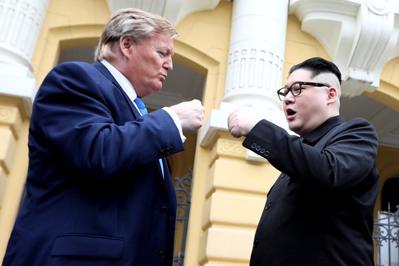 epaselect epa07386889 Kim Jong-un impersonator Howard X (R) and Donald Trump impersonator Dennis Alan (L) pose for photos outside the Opera House in Hanoi, Vietnam, 22 February 2019. The second summit ...