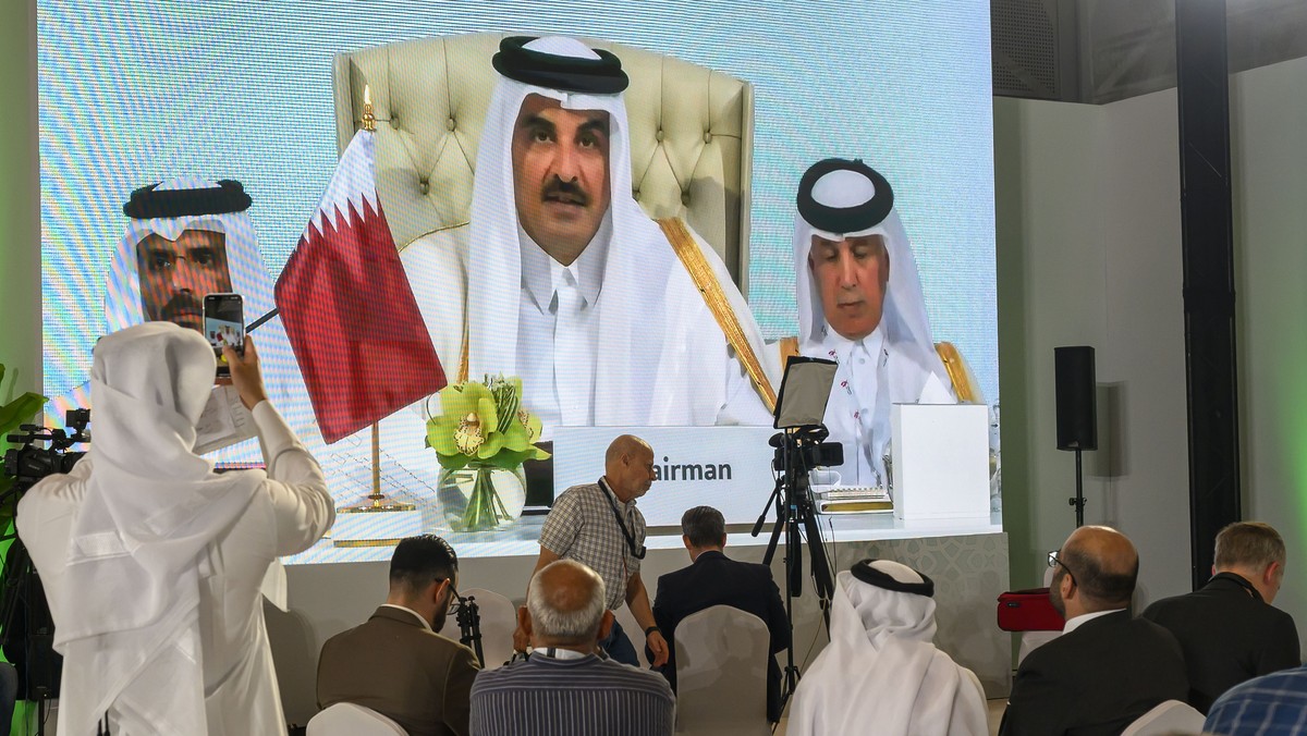 epa12380061 Journalists watch a speech by Qatar's Emir Sheikh Tamim bin Hamad Al-Thani on a screen at the media centre during the opening of the emergency Arab-Islamic summit to discuss the Israe ...