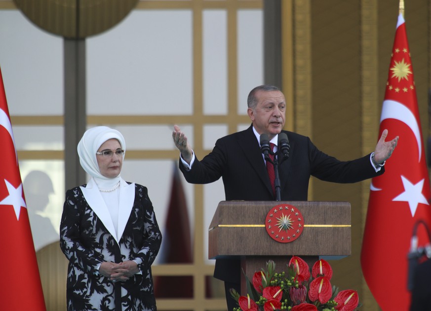 Turkey&#039;s President Recep Tayyip Erdogan, accompanied by his wife Emine, gestures as he talks during a ceremony at the Presidential Palace in Ankara, Turkey, Monday, July 9, 2018. Erdogan has been ...