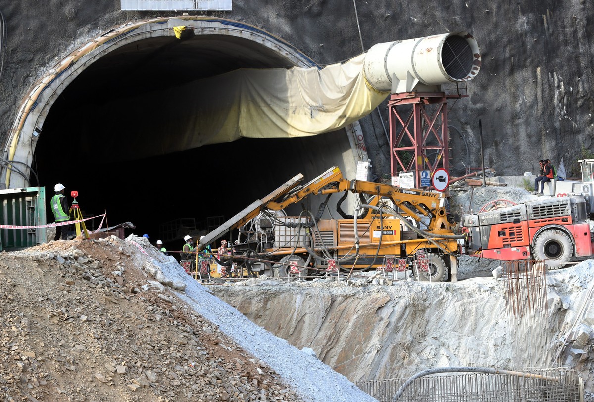epa10995888 Heavy machinery, rescue workers and experts are gathered at the mouth of a tunnel that collapsed inside, in Uttarkashi, India, 26 November 2023. Rescue and relief operations were continued ...