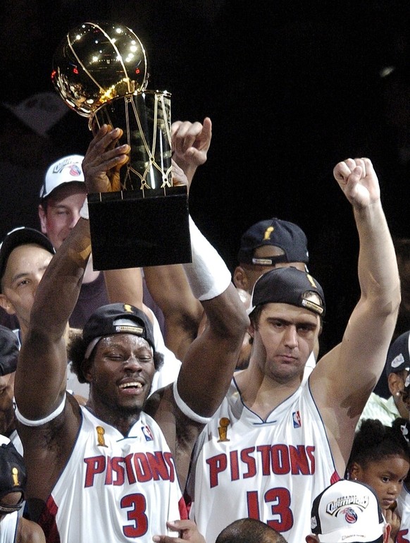 The Detroit Pistons Ben Wallace (L) holds the NBA Championship Trophy as he celebrates with teammate Mehmet Okur (R) after game five against the LA Lakers at The Palace of Auburn Hills, Michigan Tuesd ...