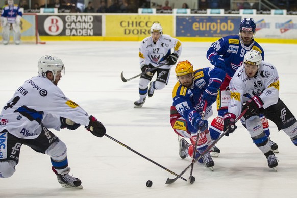 EHC Kloten Stuermer Vincent Praplan, gelber Helm, gegen HC Fribourg-Gotteron Stuermer Matthias Rossi, rechts, und Verteidiger Ralph Stalder, links, waehrend dem Eishockey-Meisterschaftsspiel der Natio ...