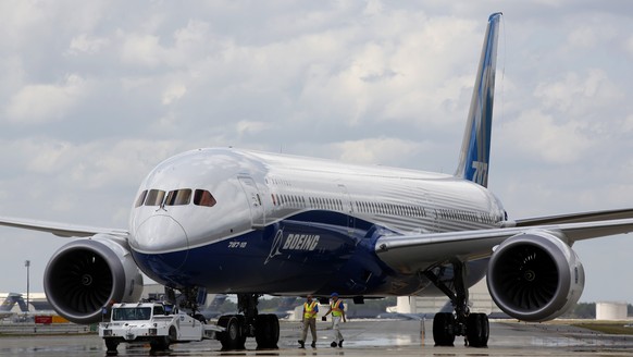 FILE - Boeing employees walk the new Boeing 787-10 Dreamliner down towards the delivery ramp area at the company&#039;s facility after conducting its first test flight at Charleston International Airp ...