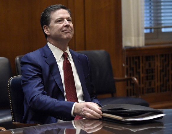 FILE - In this Feb. 9, 2017, file photo, FBI Director James Comey waits for the start of a meeting with Attorney General Jeff Session and the heads of federal law enforcement components at the Departm ...