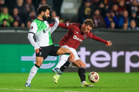epa11204934 Mohamed Salah of Liverpool (L) in action against Matej Rynes of Sparta (R) during the UEFA Europa League round of 16 first leg soccer match between Sparta Prague and Liverpool FC in Prague ...