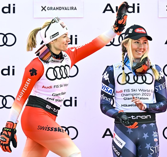 Second placed of the women&#039;s giant slalom overall classification Lara Gut-Behrami of Switzerland celebrates next to Mikaela Shiffrin of the United States during the podium ceremony at the FIS Alp ...