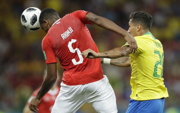 Switzerland&#039;s Manuel Akanji, left, and Brazil&#039;s Roberto Firmino challenge for the ball during the group E match between Brazil and Switzerland at the 2018 soccer World Cup in the Rostov Aren ...