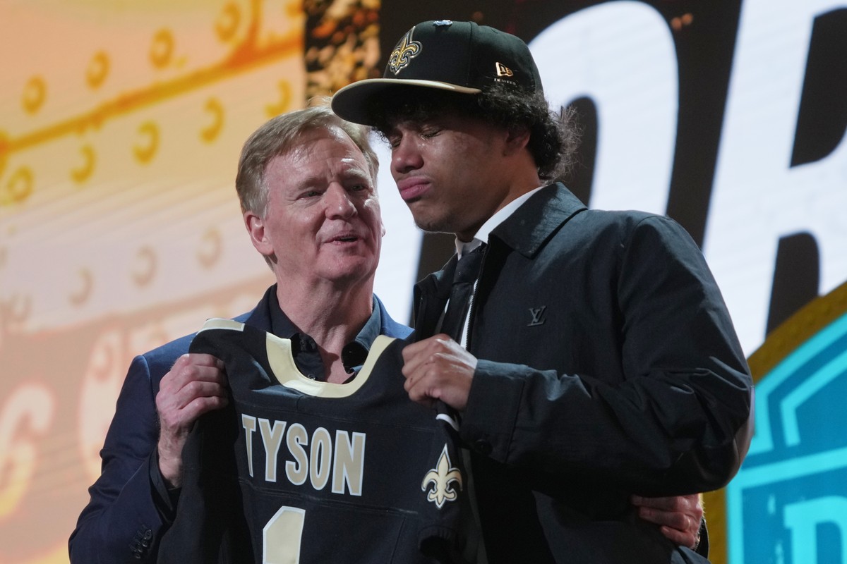 Arizona State wide receiver Jordyn Tyson cries while standing with NFL Commissioner Roger Goodell after being chosen by the New Orleans Saints with the eighth overall pick during the first round of th ...