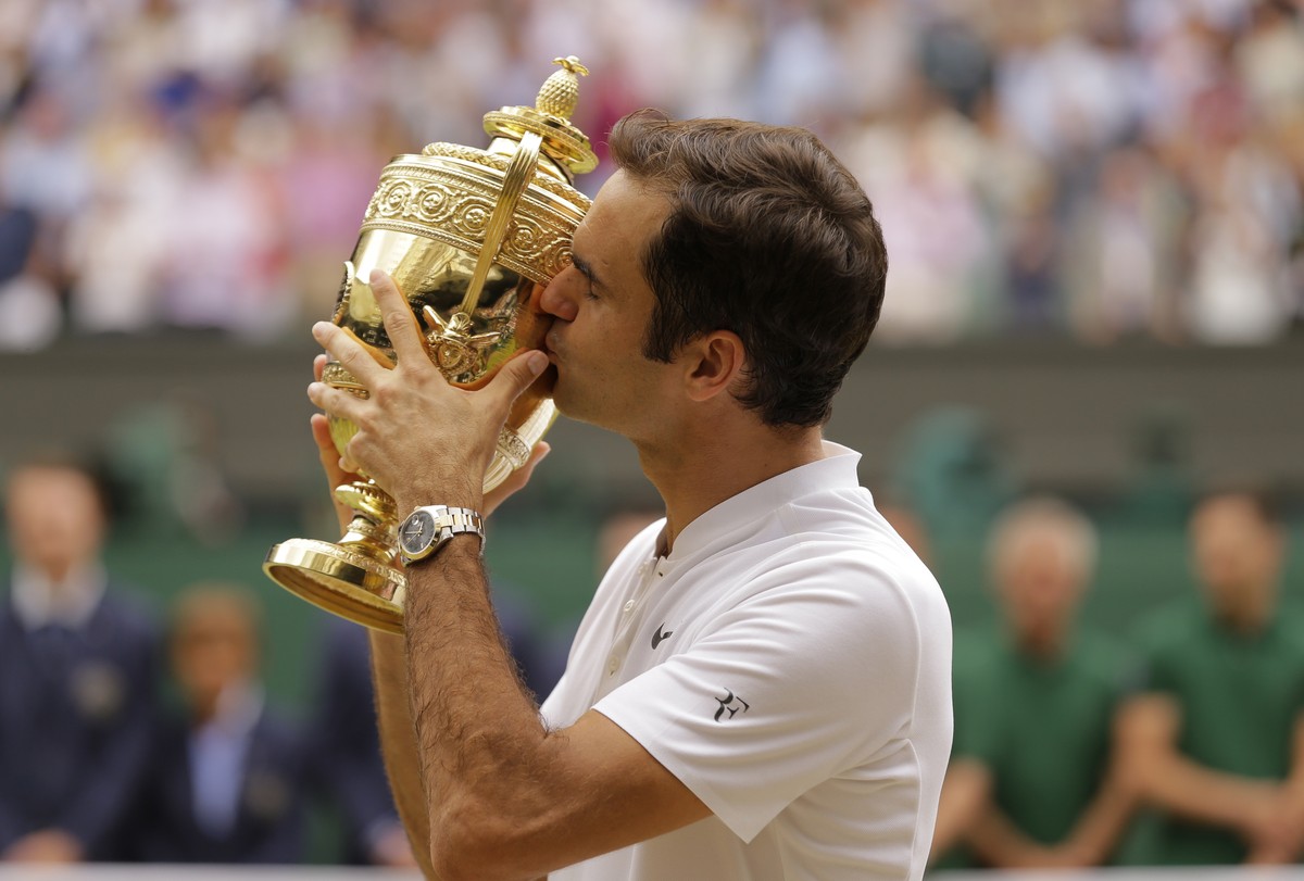 FILE - In this July 16, 2017, file photo, Switzerland's Roger Federer kisses the trophy after defeating Croatia's Marin Cilic to win the Men's Singles final match on day thirteen at the ...
