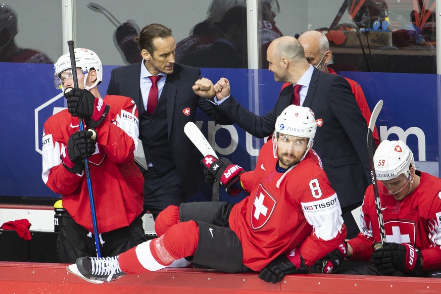 Patrick Fischer, left, head coach of Switzerland national ice hockey team, and Christian Wohlwend, right, assistant coach of Switzerland national ice hockey team, celebrate after wining against Czech  ...