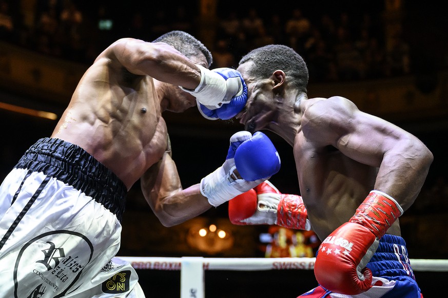 Anderson Dener of Brazil, left, fights against Cristhian Martinez of Cuba, right, in a super light fight, at the Stadttheater in Bern, Switzerland, Friday, April 15, 2022. (KEYSTONE/Anthony Anex)